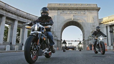 In this photo provided by Harley-Davidson, riders introduce Project LiveWire — the first electric Harley-Davidson motorcycle — as they cross the Manhattan Bridge in New York, Monday, June 23, 2014.