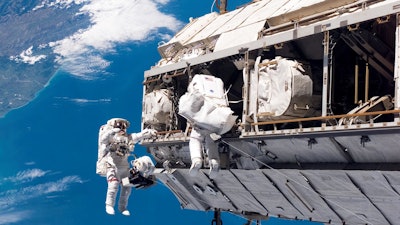 In this Dec. 12, 2006, file photo, made available by NASA, astronaut Robert L. Curbeam Jr., left, and European Space Agency astronaut Christer Fuglesang participate in a space walk during construction of the International Space Station.