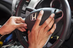 A Honda technician works on an air bag during a free air bag replacement event in Kuala Lumpur, Malaysia.