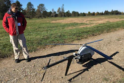 In this Oct. 17, 2017 photo, Nick Brown, a drone pilot for Pulse Aerospace of Lawrence, Kan., stands beside a Pulse Vapor unmanned aircraft at Griffiss International Airport in Rome, N.Y.