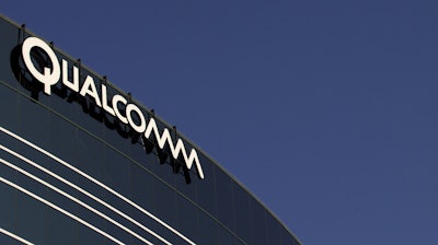 In this Nov. 2, 2011, file photo, a sign sits atop the Qualcomm headquarters building in San Diego.