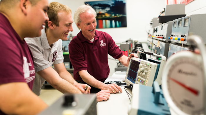 Engineering technology students work with College of Engineering Assistant Professor Rolfe Sassenfeld on equipment, May 15, 2015.