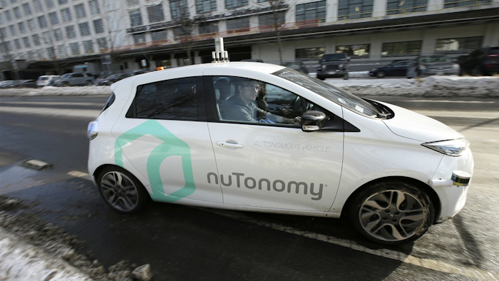 In this Tuesday, Jan. 10, 2017, photo, an autonomous vehicle is driven by an engineer on a street through an industrial park, in Boston.