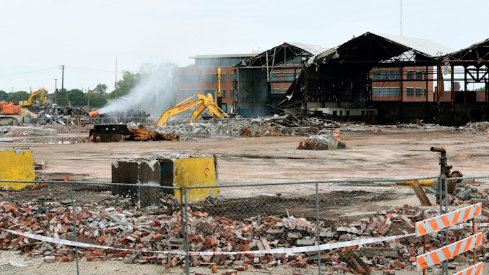 In this Thursday, Sept. 27, 2018 photo, work crews clear an industrial warehouse site of steel and bricks in a lot at Crawford Street and South Street in the Delray neighborhood in Detroit.