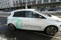 In this Tuesday, Jan. 10, 2017, photo, an autonomous vehicle is driven by an engineer on a street through an industrial park, in Boston.