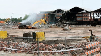 In this Thursday, Sept. 27, 2018 photo, work crews clear an industrial warehouse site of steel and bricks in a lot at Crawford Street and South Street in the Delray neighborhood in Detroit.