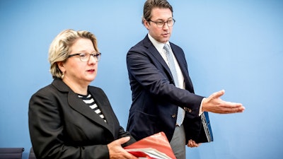 German Transportation Minister Andreas Scheuer, right, and German Environment Minister Svenja Schulze, left, arrive for a news conference in Berlin, Wednesday, Oct. 2, 2018.