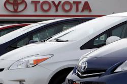 This Feb. 19, 2012, file photo shows a line of 2012 Prius sedans at a Toyota dealership in the south Denver suburb of Littleton, Colo.