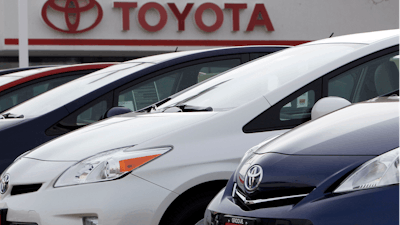 This Feb. 19, 2012, file photo shows a line of 2012 Prius sedans at a Toyota dealership in the south Denver suburb of Littleton, Colo.