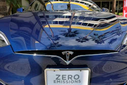 In this Oct. 24, 2016, file photo, palm trees are reflected on the hood of a Tesla Model S on display in downtown Los Angeles.