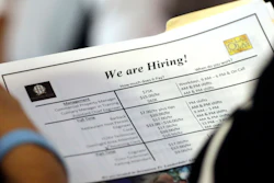 In this June 21, 2018 file photo, a job applicant looks at job listings for the Riverside Hotel at a job fair hosted by Job News South Florida, in Sunrise, Fla.