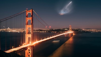 In this photo taken Sunday, Oct. 7, 2018 and provided by Justin Borja, a SpaceX Falcon 9 rocket launch is seen in the distance over the Golden Gate Bridge near Sausalito, Calif.