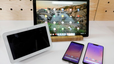 The Google Home Hub, left, Pixel Slate, center, and two new smartphones are displayed in New York, Tuesday, Oct. 9, 2018.