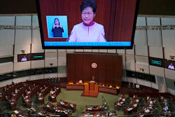 A video screen shows Hong Kong Chief Executive Carrie Lam delivering her policy speech at the Legislative Council in Hong Kong Wednesday, Oct. 10, 2018.