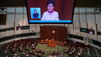 A video screen shows Hong Kong Chief Executive Carrie Lam delivering her policy speech at the Legislative Council in Hong Kong Wednesday, Oct. 10, 2018.