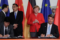 In this July 9, 2018 file photo German Chancellor Angela Merkel and Chinese Premier Li Keqiang attend a contracts signing ceremony between German car maker BMW CEO Harald Krueger and Qi Yumin CEO of the Brilliance Group during a meeting in the chancellery in Berlin.