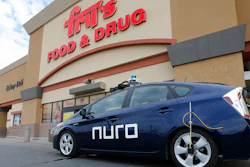This Aug. 16, 2018, file photo shows a self-driving Nuro vehicle parked outside a Fry's supermarket, which is owned by Kroger, as part of a pilot program for grocery deliveries in Scottsdale, Ariz.