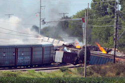 In this June 18, 2018, file photo, workers cut power to lines surrounding derailed CSX train cars as they continue to burn the morning after an explosion of a propane tank in Princeton, Ind.