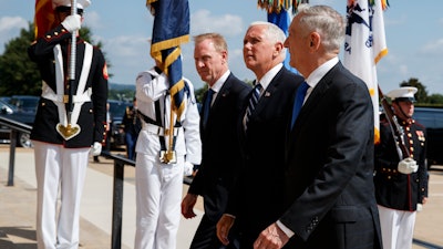 In this Aug. 9, 2018 file photo, Vice President Mike Pence, center, is greeted by Deputy Secretary of Defense Pat Shanahan, left, and Secretary of Defense Jim Mattis before speaking at an event on the creation of a United States Space Force at the Pentagon.