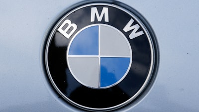 In this Aug. 1, 2017 file photo the brand logo of German car maker BMW is photographed on a car in Berlin.