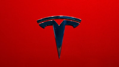 This Oct. 3, 2018, file photo shows the logo of Tesla model 3 at the Auto show in Paris.