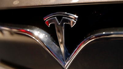 This Oct. 3, 2018, file photo shows a Tesla emblem at the Auto show in Paris.