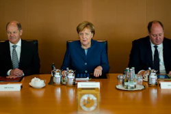 German Chancellor Angela Merkel sits between Vice-chancellor and Finance Minister Olaf Scholz, left, Head of Chancellery and Minister for Special Tasks Helge Braun, right, as she leads the weekly cabinet meeting of the German government at the chancellery in Berlin, Wednesday, Oct. 24, 2018.
