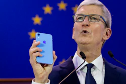 Apple CEO Tim Cook holds up an iPhone as he speaks during a data privacy conference at the European Parliament in Brussels, Wednesday, Oct. 24, 2018.