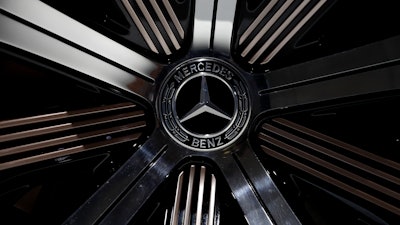 In this Feb. 2, 2017 file photo the logo of Mercedes-Benz E-Class Coupe is photographed prior to the annual balance news conference at the company's headquarters in Stuttgart, Germany.