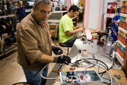 In this Thursday, Oct. 18, 2018, photo Sarmad Eskandar, left, and Mustpha Damen work on electrical components at the Howard McCray's commercial refrigeration manufacturing facility in Philadelphia.