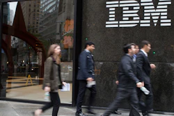 In this April 26, 2017, file photo, pedestrians walk past the IBM logo displayed on the IBM building in New York.