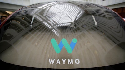 In this Dec. 13, 2016, file photo, a skylight is reflected in the rear window of a Waymo driverless car during a Google event in San Francisco.
