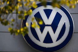 The VW sign of Germany's Volkswagen car company is displayed at the building of a company's retailer in Berlin.