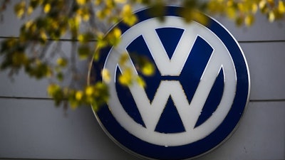 The VW sign of Germany's Volkswagen car company is displayed at the building of a company's retailer in Berlin.