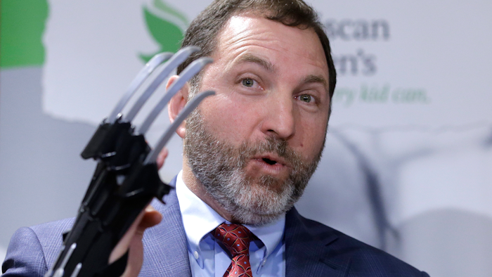 James Swartz, director of W.A.T.C.H., displays a Black Panther 'slash claw' as he introduces toys topping the group's annual list of worst toys for the holiday season.