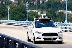 Uber employees testing a self-driving Ford Fusion in Pittsburgh.