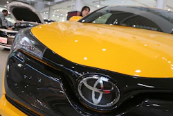 In this Nov. 13, 2017, photo, visitors take a look at Toyota cars at the automaker's showroom in Tokyo.