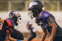 In this photo provided by VICIS, youth football players wear the company's new youth helmets during a helmet test-fitting and practice in Seattle.