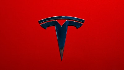 This Oct. 3, 2018, file photo shows the logo of Tesla Model 3 at the Auto show in Paris.