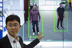 In this Oct. 31, 2018, photo, Huang Yongzhen, CEO of Watrix, demonstrates the use of his firm's gait recognition software at his company's offices in Beijing.