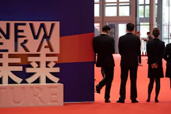 Workers wait for attendees to arrive at the China International Import Expo held in Shanghai, Monday, Nov. 5, 2018.