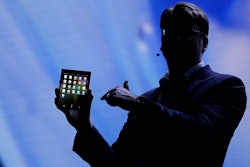 Justin Denison, SVP of Mobile Product Development, shows off the Infinity Flex Display of a folding smartphone Wednesday, Nov. 7, 2018.