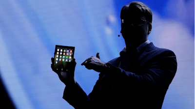 Justin Denison, SVP of Mobile Product Development, shows off the Infinity Flex Display of a folding smartphone Wednesday, Nov. 7, 2018.