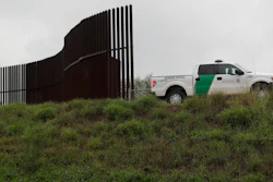 This Nov. 13, 2016, file photo shows a U.S. Customs and Border Patrol agent passes along a section of border wall in Hidalgo, Texas.