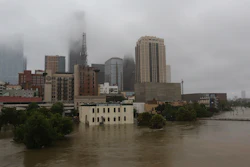 In this Monday, Aug. 28, 2017 file photo, floodwaters from Tropical Storm Harvey overflow from Buffalo Bayou in downtown Houston.