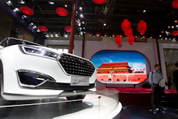 In this file photo taken Monday, April 25, 2016, visitors to Auto China 2016 stand near Zotye Auto's T300 SUV displayed in Beijing.