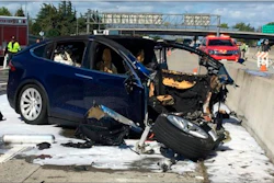 In this March 23, 2018 file photo, emergency personnel work a the scene where a Tesla electric SUV crashed into a barrier on U.S. Highway 101 in Mountain View, Calif.