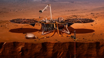 This illustration made available by NASA in 2018 shows the InSight lander drilling into the surface of Mars.