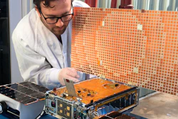 In this undated photo, engineer Joel Steinkraus uses sunlight to test the solar arrays on one of the Mars Cube One project in Pasadena, Calif.