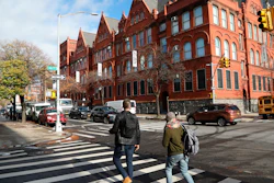 People cross the street next to the MOMA PS1 art museum in Long Island City, near the site for a proposed Amazon headquarters.